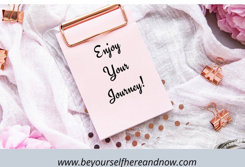 Clipboard with a pink paper saying "Enjoy your journey!" on a pink scarf. Because "How to unblock patience" is a journey.